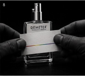 Hands placing a paper strip across a Demeter bottle